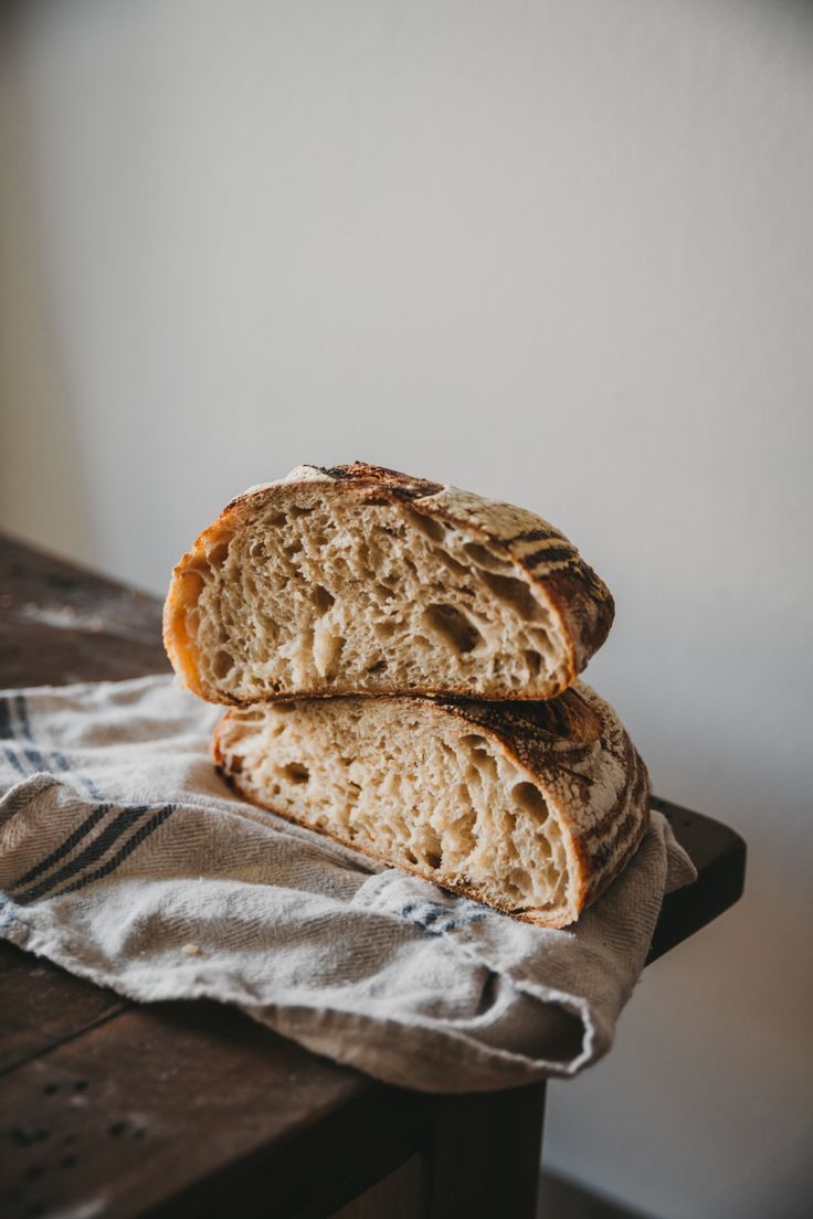 Two sourdough halves stacked on a linen cloth