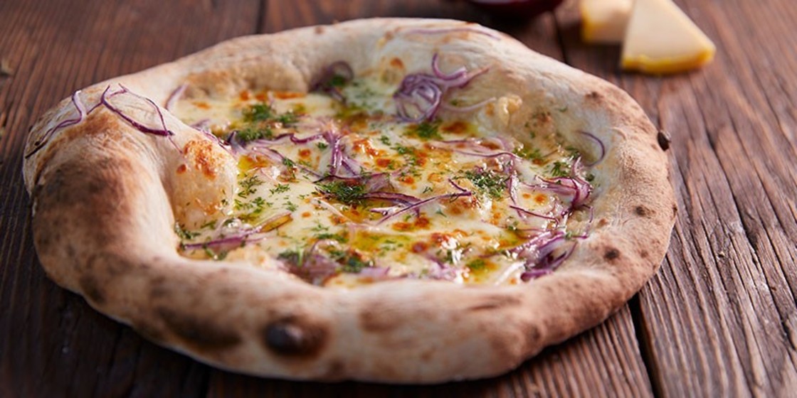 Sourdough white pizza with cheese, red onion and parsley